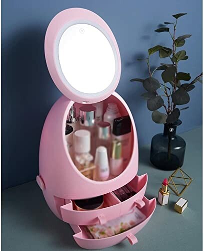 Organisateur de maquillage rose avec miroir et tiroirs.